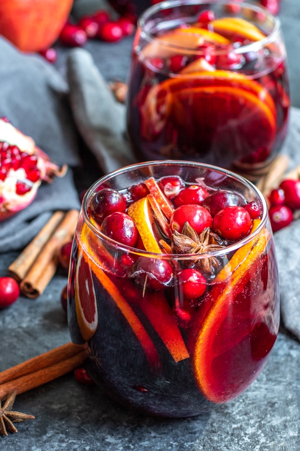 Winter Red Wine Sangria surrounded by pomegranate seeds, and whole spices