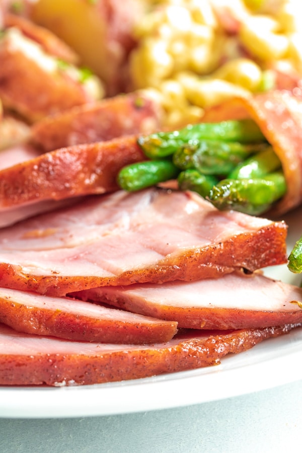 Honey glazes ham on a plate with sides