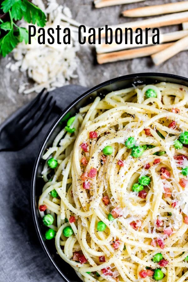 This authentic pasta carbonara recipe is an easy spaghetti carbonara made with a creamy sauce of eggs, and pecorino romano cheese, tossed with pancetta and peas. This creamy pasta carbonara can also be made with bacon and without peas. It's the best spaghetti carbonara recipe and so easy to make! #pasta #bacon #spaghetti #easydinnerrecipes #homemadeinterest
