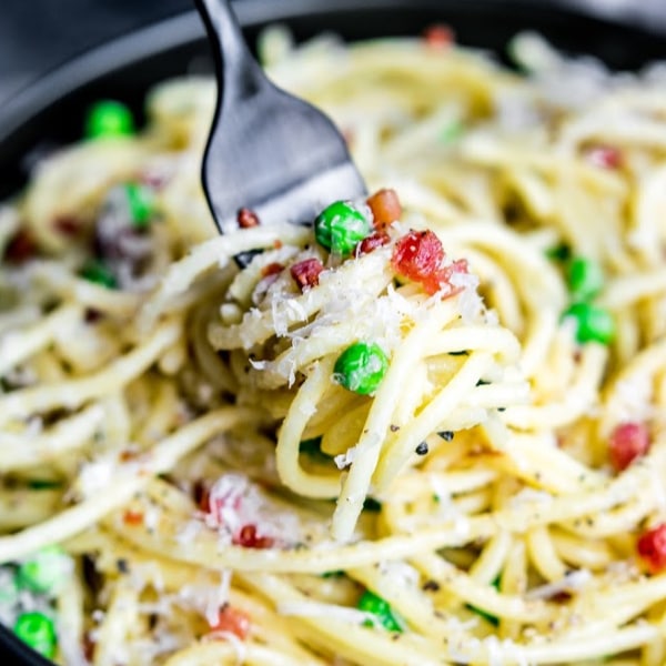 A fork twirled in pasta carbonara 