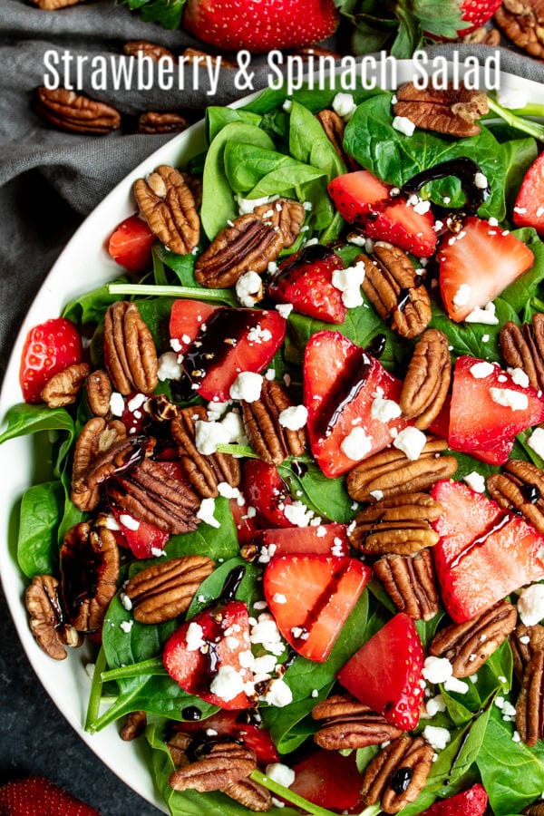 This beautiful Strawberry Spinach Salad is tossed with balsamic vinegar dressing for a healthy summer salad. This is an easy salad recipe with fresh strawberries, baby spinach, pecans, and goat cheese. You can also substitute walnuts, almonds or candied pecans! Make this easy summer salad for Easter dinner, Mother's day brunch, Memorial Day, 4th of July, or Labor day picnics! #easter #mothersday #4thofjuly #healthy #salad #strawberries #homemadeinterest
