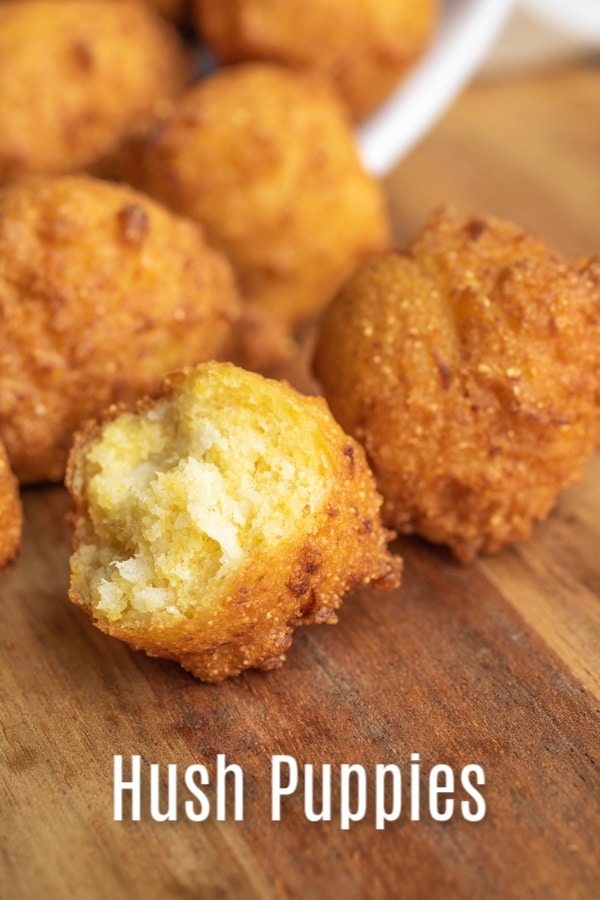 This homemade Southern Hush Puppies recipe is made with cornmeal and onions that are fried until perfectly crispy. It's an easy southern recipe that is a classic side dish for a fish fry, or fried shrimp. It's the BEST hush puppies recipe you'll ever make! #corn #cornbread #hushpuppies #southerrecipe #homemadeinterest