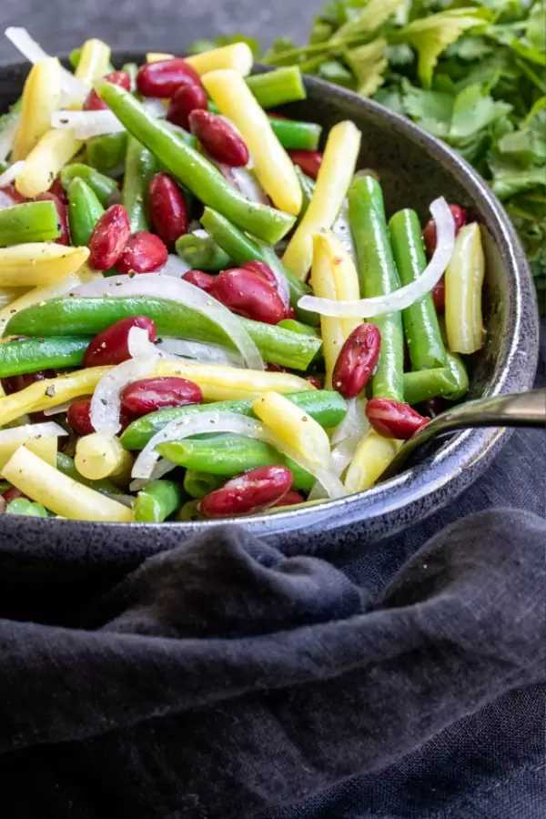 A large bowl filled with green beans, wax beans, and kidney beans.