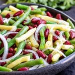 Three Bean salad made with green beans, wax beans, and kidney beans in a black bowl.