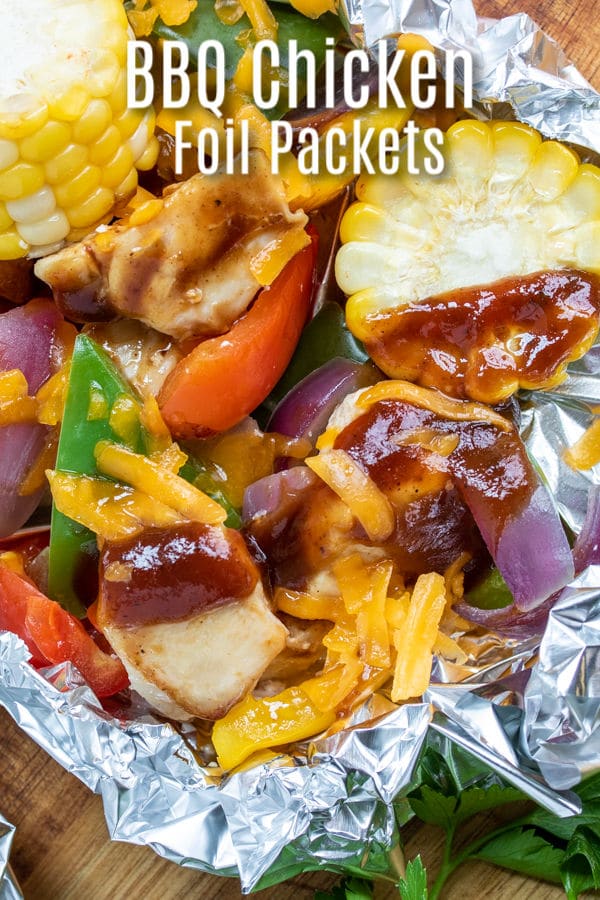 These easy Cheddar BBQ Foil Packet Meals (hobo dinners) are the perfect camping recipe and they can also be cooked on the grill or in the oven. BBQ sauce, chicken and veggies and a little cheese cooked in a simple foil packet makes a great summer dinner ! #chicken #foilpacket #hobodinner #bbqsauce