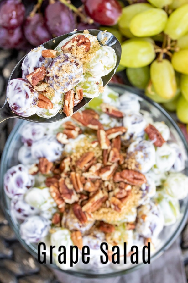 This Easy Grape Salad recipe is a creamy fruit salad made with cream cheese and sour cream tossed with grapes, and topped with brown sugar and crunchy pecans. It's an easy Southern side dish that is perfect for summer parties, BBQs, and potlucks. This dessert salad can even be made with Butterfingers or Snickers! #fruitsalad #potluckrecipes #grapes #dessert #creamcheese #homemadeinterest