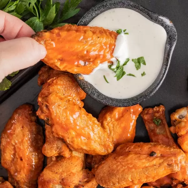 dipping Air Fryer Chicken Wings in ranch