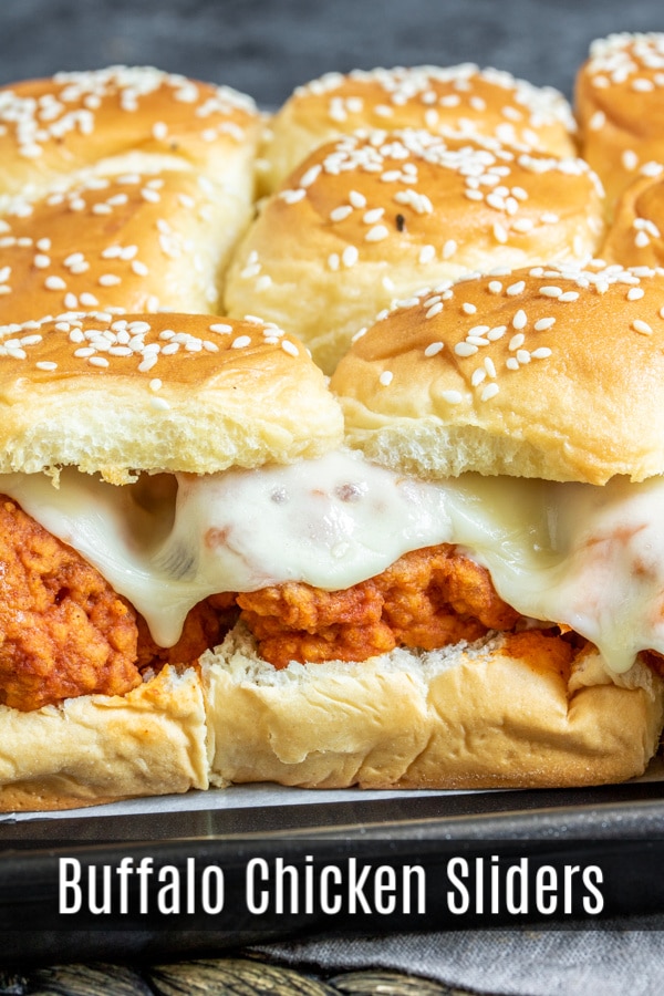 These delicious Buffalo Chicken Sliders are crispy fried chicken tender tossed in spicy buffalo wing sauce topped with provolone cheese and sandwiched between sweet Hawaiian slider rolls. These easy sliders are baked in the oven until the rolls are toasted and the cheese is perfectly melted. The ultimate game day appetizer for football parties, the Super Bowl, March Madness, or just a party with friends. #gameday #sliders #chicken #buffalochicken #homemadeinterest