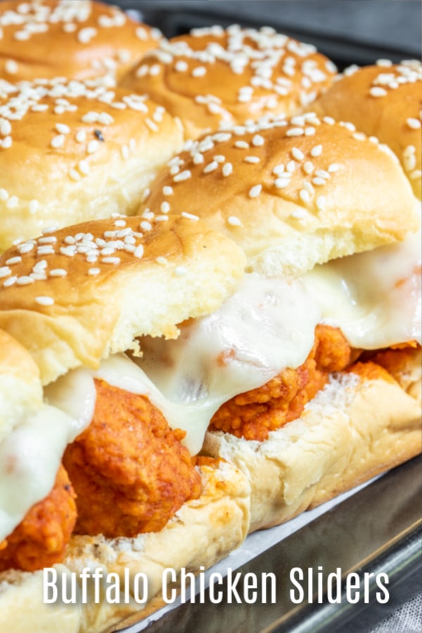 These delicious Buffalo Chicken Sliders are crispy fried chicken tender tossed in spicy buffalo wing sauce topped with provolone cheese and sandwiched between sweet Hawaiian slider rolls. These easy sliders are baked in the oven until the rolls are toasted and the cheese is perfectly melted. The ultimate game day appetizer for football parties, the Super Bowl, March Madness, or just a party with friends. #gameday #sliders #chicken #buffalochicken #homemadeinterest