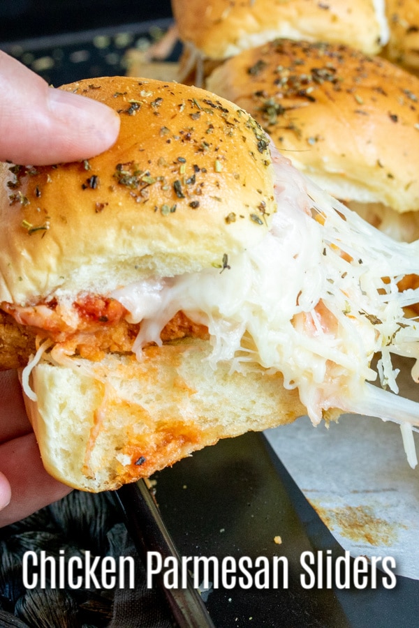 These Chicken Parmesan sliders are an easy baked slider recipe that is perfect Super Bowl Party food, March Madness party food, or just a family dinner that everyone is going to love. Chicken tenders, tomato sauce, and lots of mozzarella cheese on a slider roll make this chicken sandwich the perfect football party food. #gamedayfood #gameday #chicken #sliders #homemadeinterest #appetizer #partyfood
