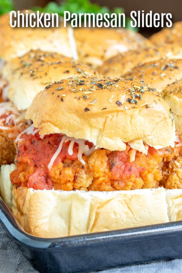 These Chicken Parmesan sliders are an easy baked slider recipe that is perfect Super Bowl Party food, March Madness party food, or just a family dinner that everyone is going to love. Chicken tenders, tomato sauce, and lots of mozzarella cheese on a slider roll make this chicken sandwich the perfect football party food. #gamedayfood #gameday #chicken #sliders #homemadeinterest #appetizer #partyfood