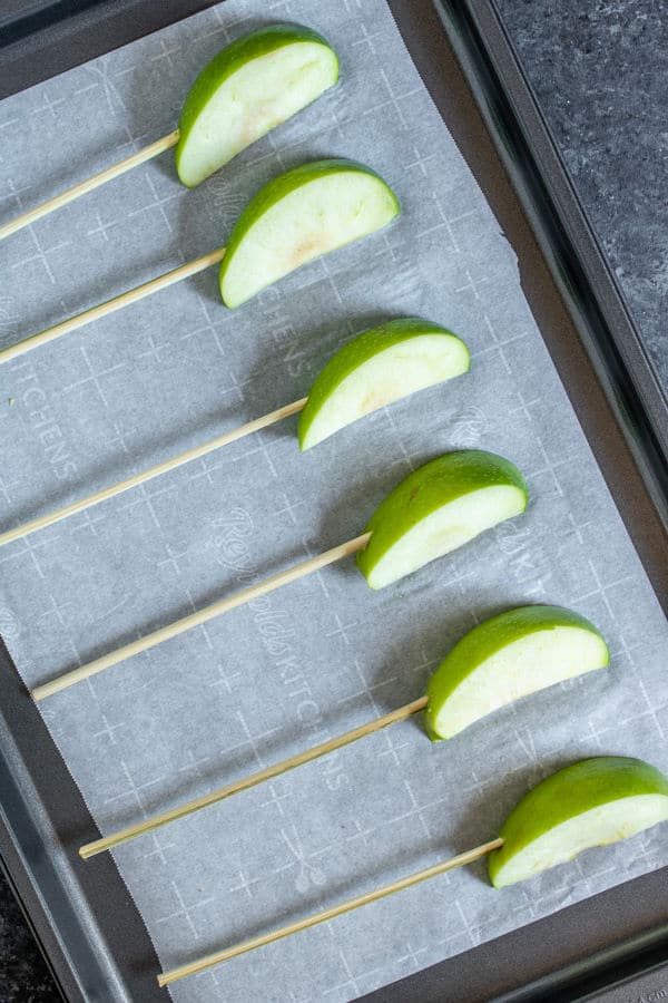 slices of apples on a kabob stick to make Chocolate Covered Apple Kabobs