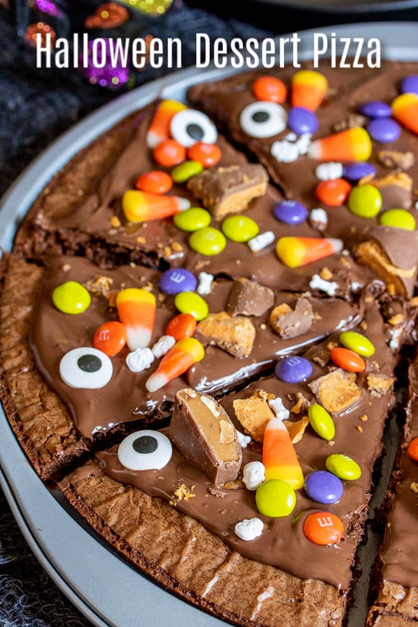 Halloween Dessert Pizza starts with a box of brownie mix and your favorite Halloween candy and bakes up into a delicious Halloween recipe for a party. This easy Halloween recipe idea uses brownie mix, Nutella, and Halloween candy to make a delicious Halloween dessert for kids and adults. It's perfect for parties and a great way to use up leftover Halloween candy. #halloween #halloweenparty #dessert #brownies #candy #homemadeinterest
