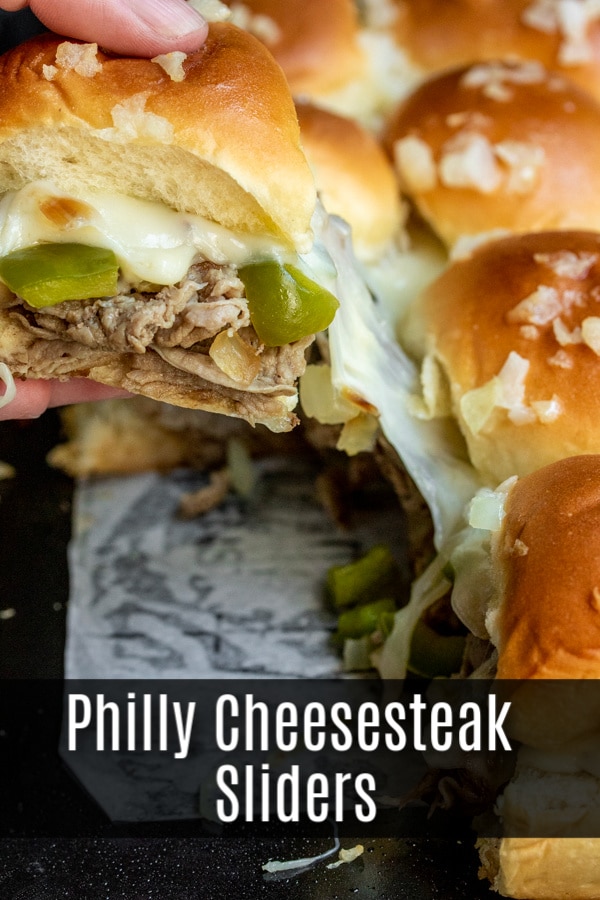 These Philly Cheesesteak sliders are a great football party food idea that is perfect for a crowd. Baked sliders filled with thinly sliced steak, provolone cheese, peppers, and onions make the ultimate Super bowl recipe, March Madness recipe, party appetizer, or just an awesome weeknight dinner recipe. #football #gameday #appetizer #sliders #phillycheesesteak #homemadeinterest