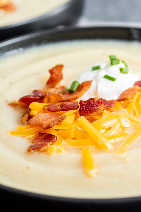 Instant Pot Loaded Cauliflower Soup topped with bacon and cheese