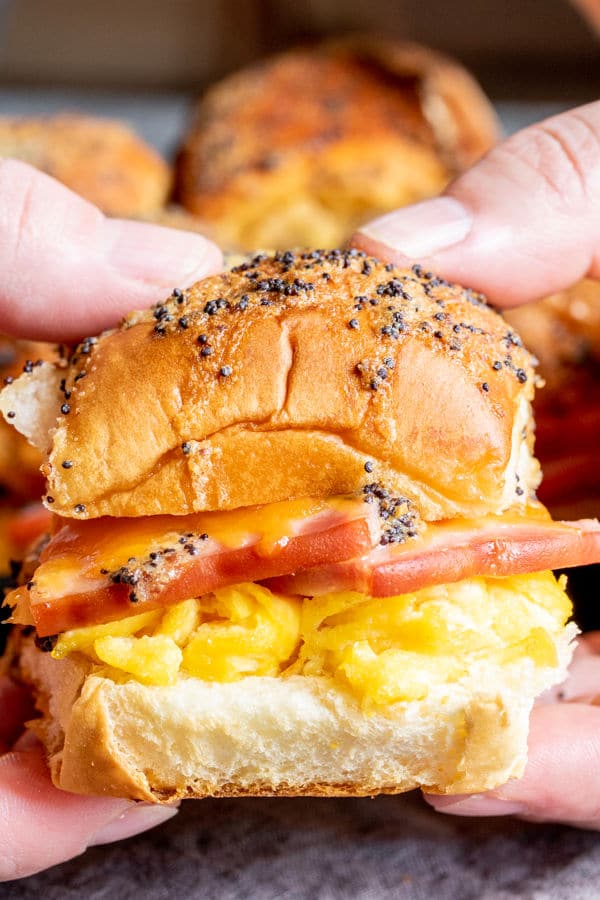 Hands holding a Ham Egg and Cheese Breakfast Slider