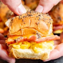 Hands holding a Ham Egg and Cheese Breakfast Slider