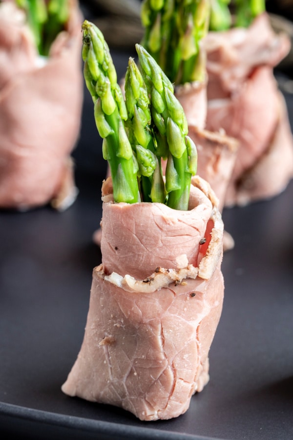 Roast Beef and Asparagus Roll Ups cut in half and sitting upright as a beautiful low carb appetizer