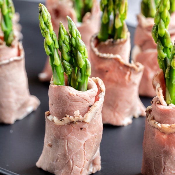 Roast Beef and Asparagus Roll Ups cut in half to make small keto appetizers