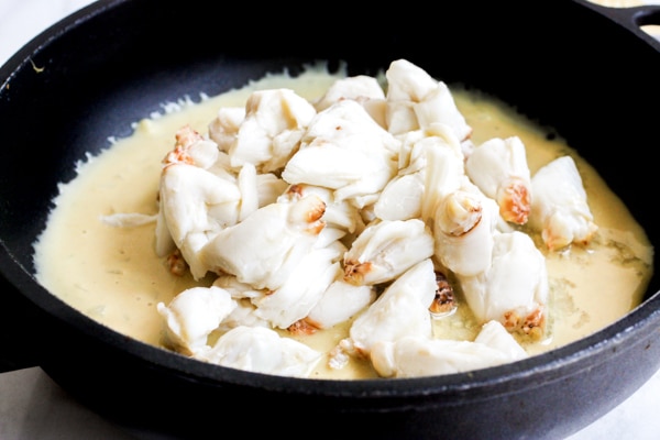 Lump crab meat being cooked in a flavorful sauce