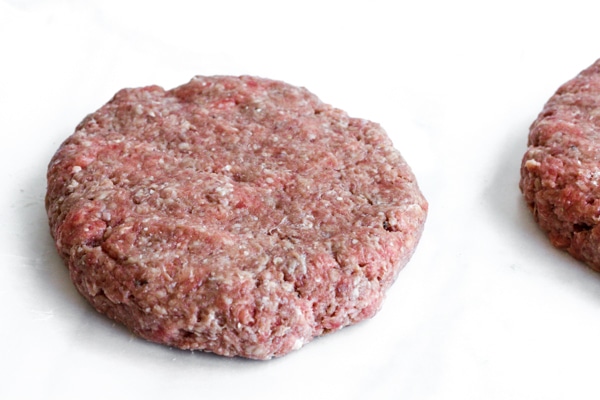 Burger patty made from ground beef and lightly seasoned