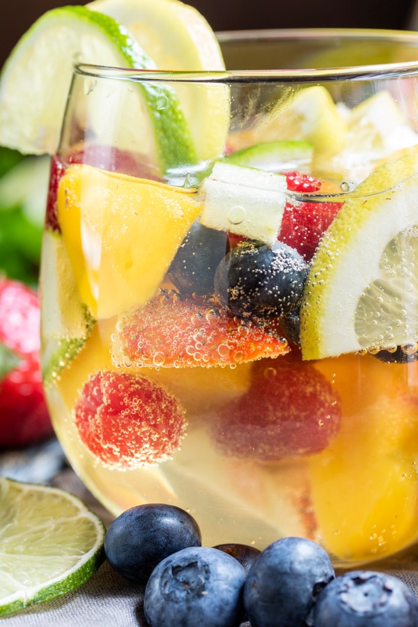Close-up of Summer Moscato Sangria glass loaded with fresh juicy fruit