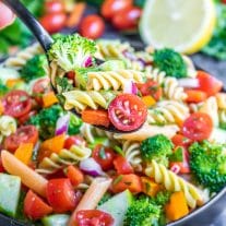 spoonful of vegan pasta salad over a bowl of vegan pasta salad