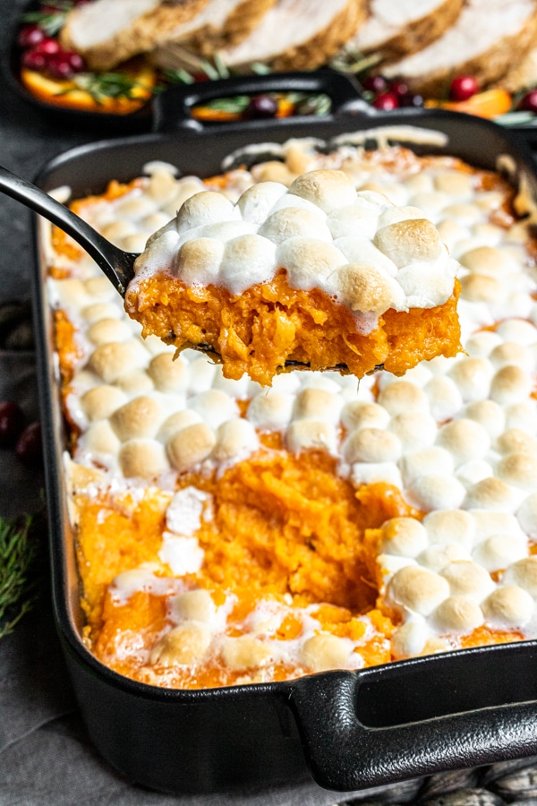 serving Sweet Potato Casserole with Marshmallows for Thanksgiving