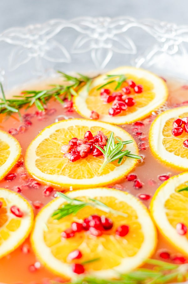 orange slices on top of Christmas Punch bowl