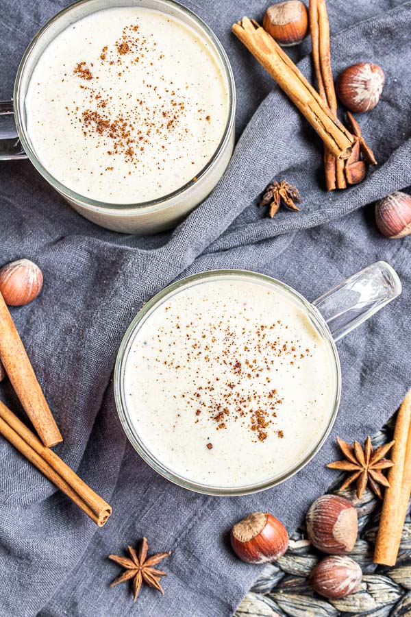 two cups of Keto Eggnog with cinnamon and nutmeg