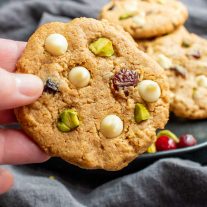 holding a Keto Pistachio and Cranberry Cookies