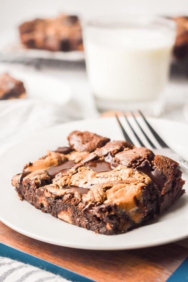 Dark Chocolate Peanut Butter Brownies on a white plate with a glass of milk