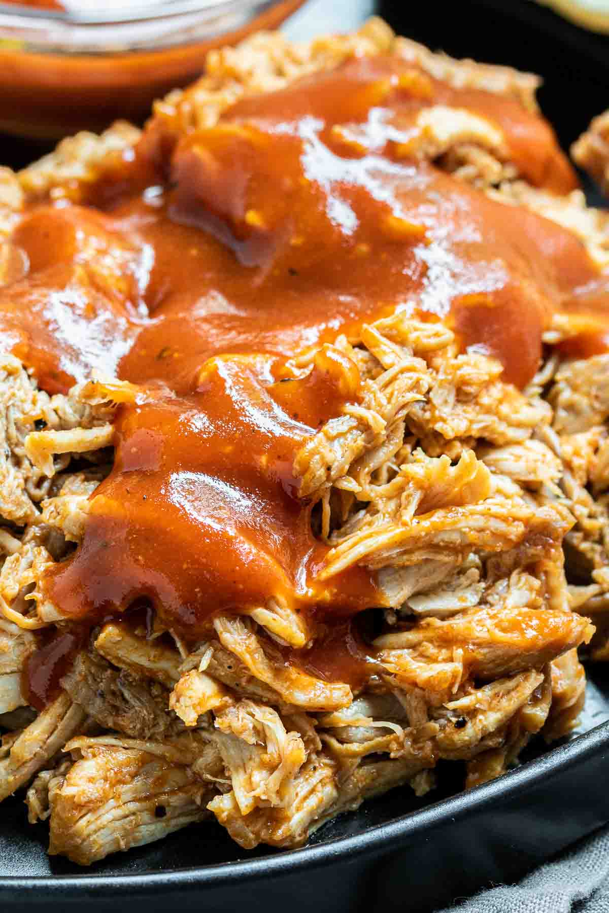 Close up of Instant Pot Pulled Pork and BBQ sauce