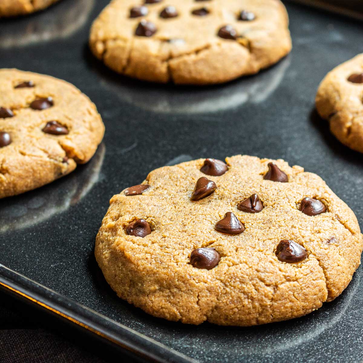 Keto Peanut Butter Cookies with Chocolate Chips on a black sheet pan