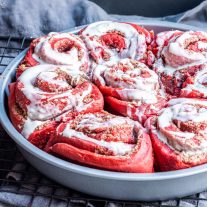 Red Velvet Cinnamon Rolls in a round pan