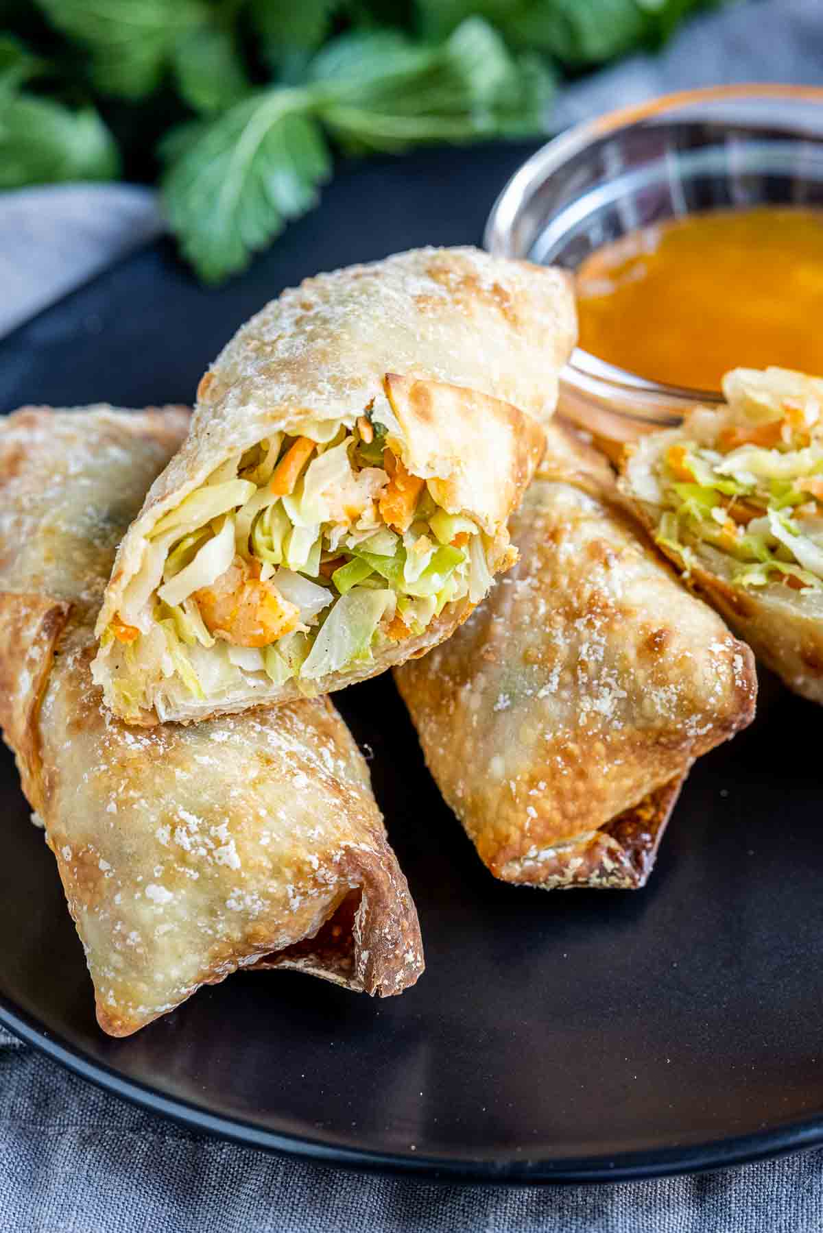 An Air Fryer Egg Rolls with shrimp cut in half to show the ingredients inside. 