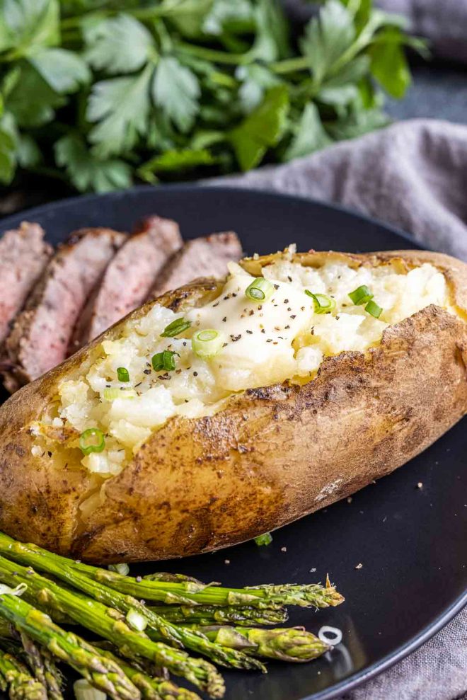 Instant Pot Baked Potatoes topped with butter and chives