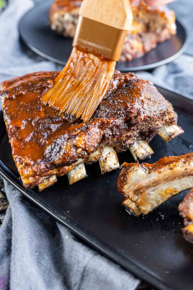 brushing bbq sauce on Instant Pot Ribs