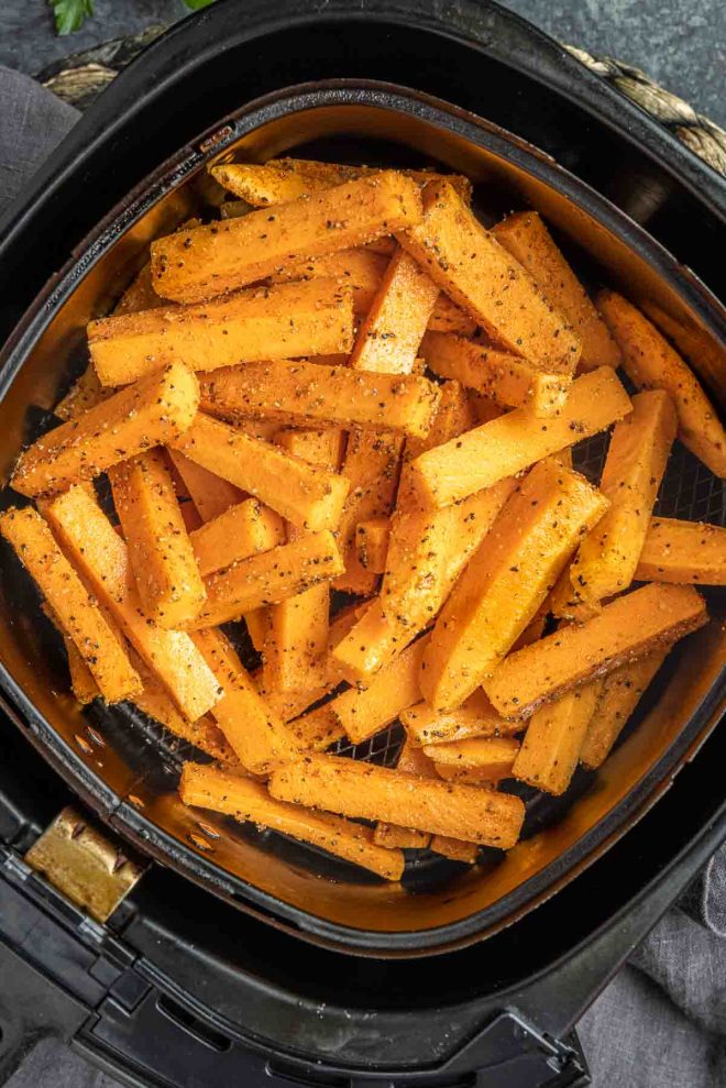 raw Air Fryer Sweet Potato Fries in air fryer basket