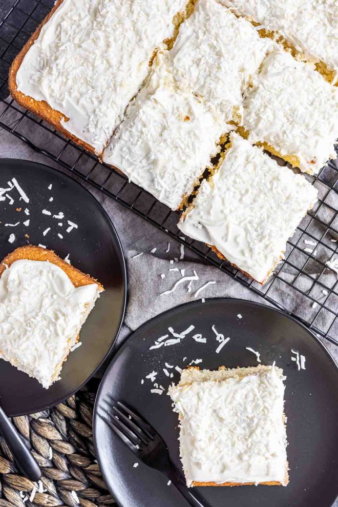 Coconut Sheet Cake cooling on rack with slices on plates