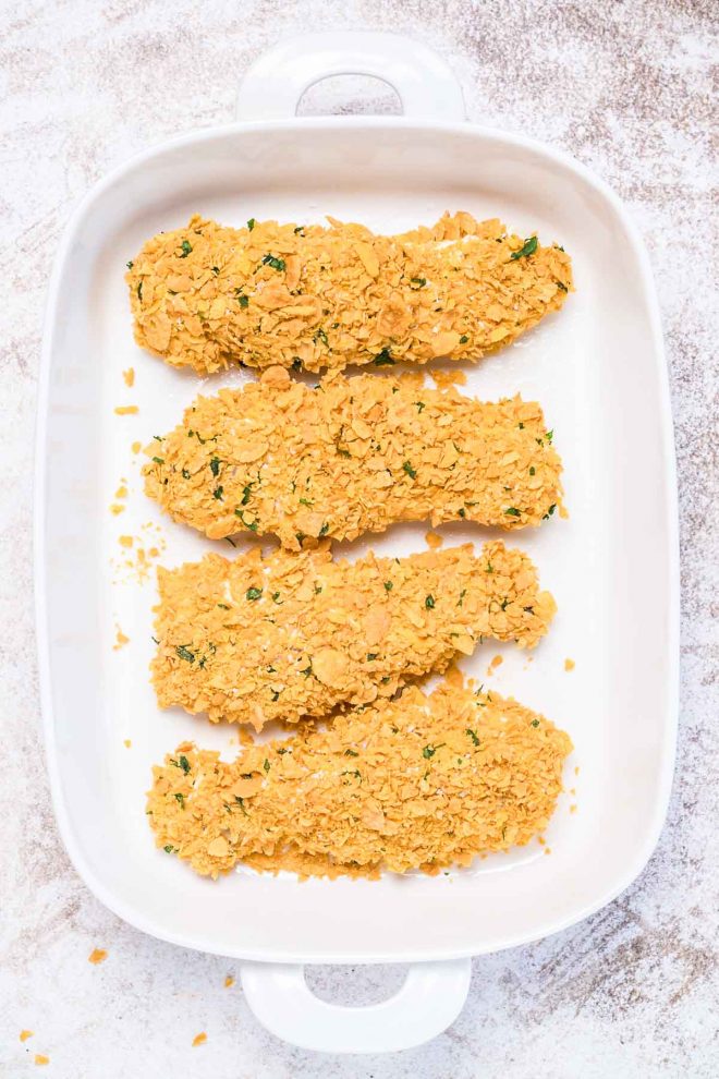 Cornflake Chicken tenders in a baking dish