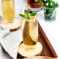 Mint Julep on a wooden tray garnished with mint
