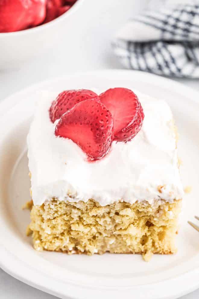 Tres Leches Cake with frosting and strawberries