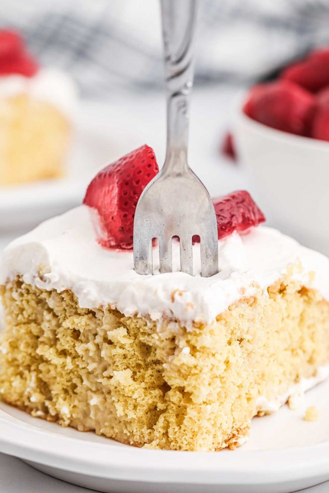 Tres Leches Cake on a plate with a fork in it