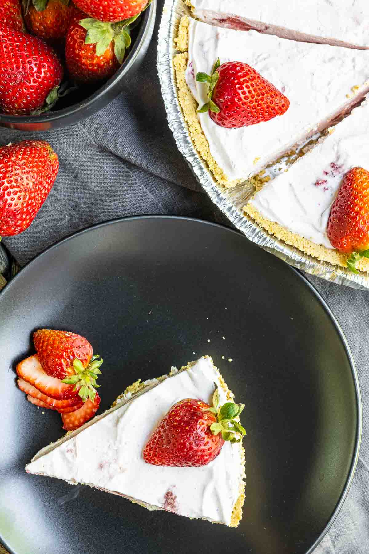 Frozen Strawberry Pie slice on a plate with whole pie next to it