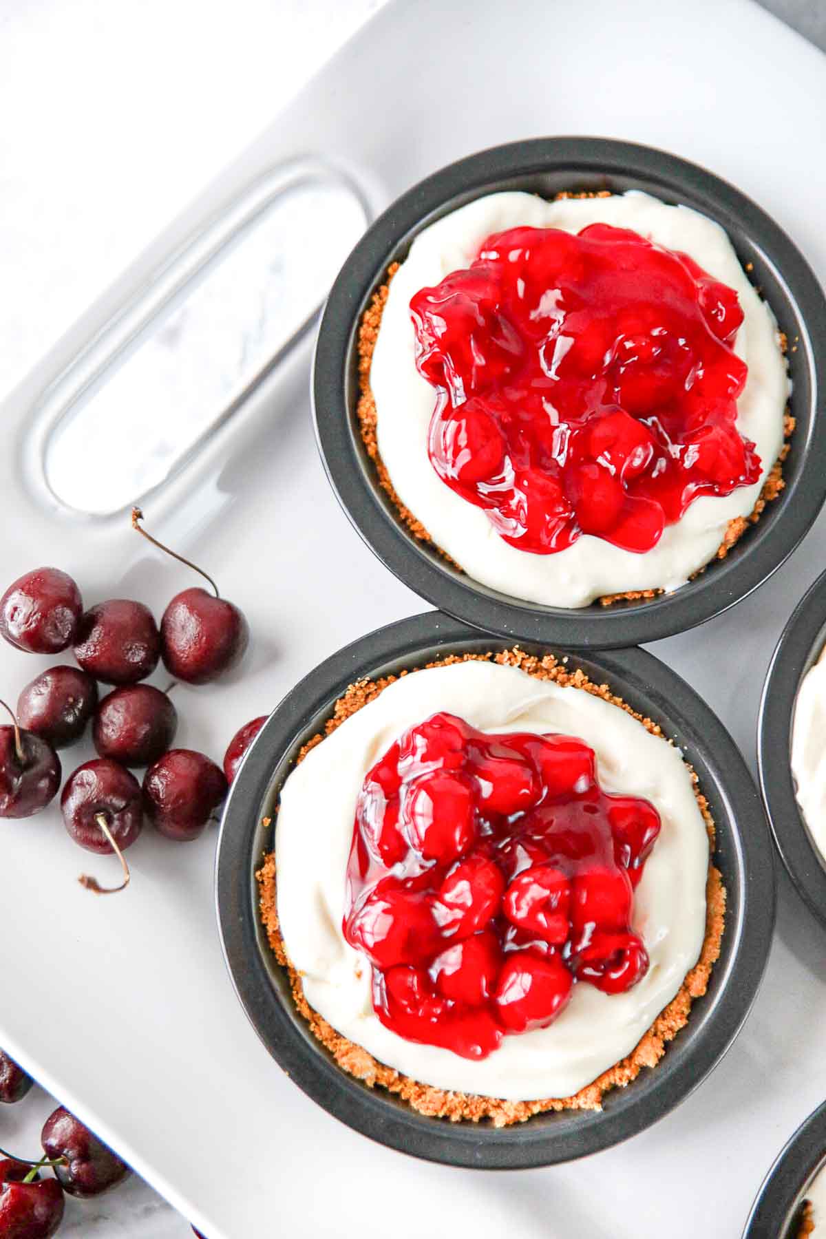 No Bake Cherry Cheesecake on platter with fresh cherries