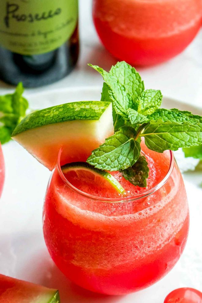 Frozen Watermelon Cocktail in a glass garnished with mint and watermelon slice
