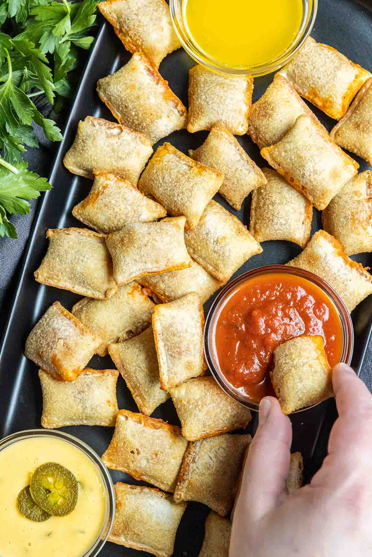 dipping Air Fryer Pizza Rolls in sauce