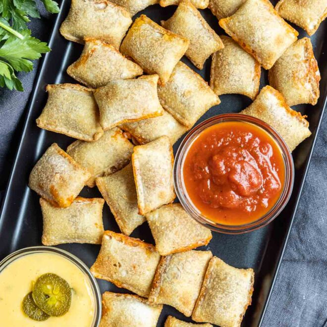 dipping Air Fryer Pizza Rolls in pizza sauce