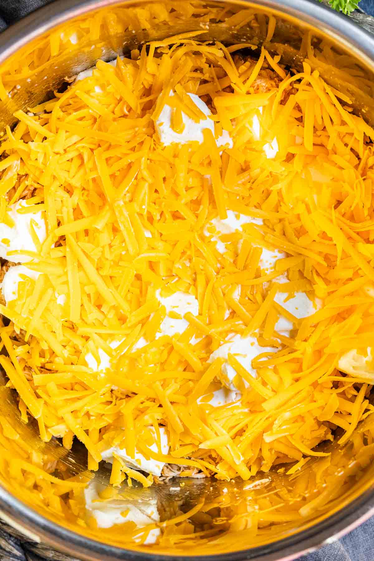 Instant Pot Buffalo Chicken Dip with shredded cheddar cheese and cream cheese